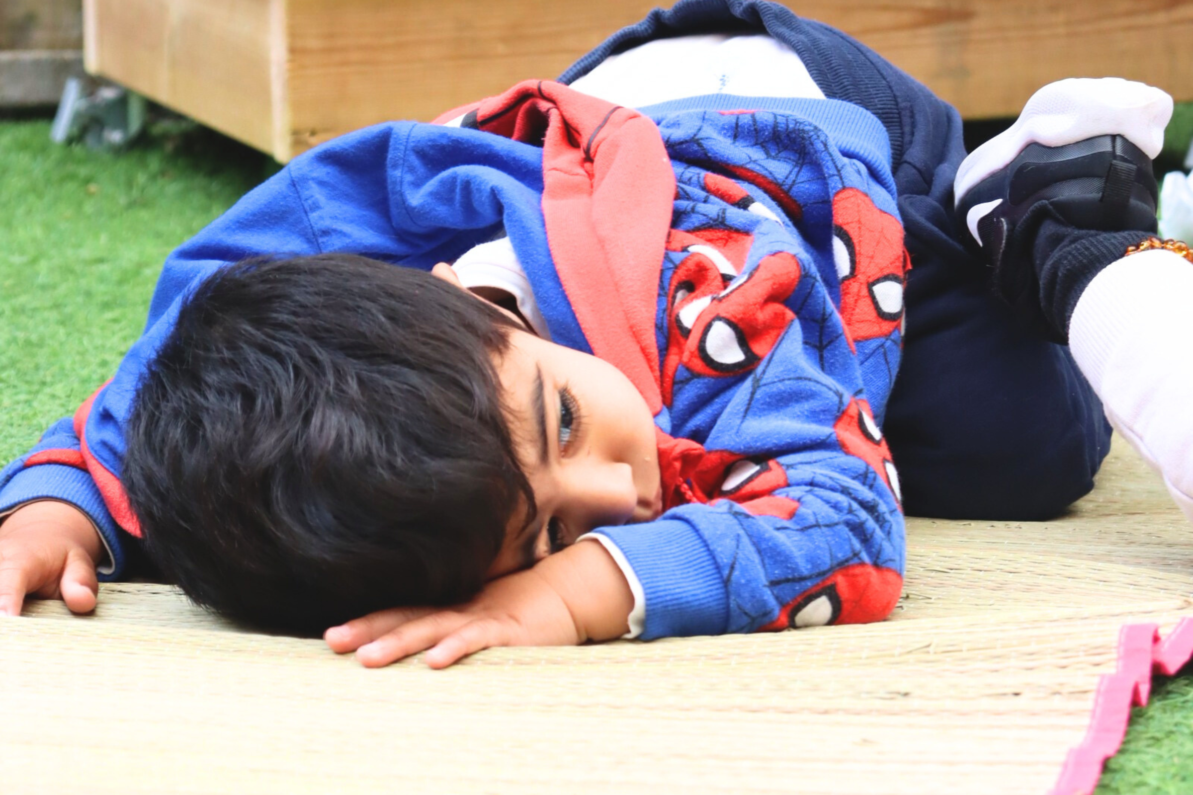 one of Budding Learners babies smiling to one of the Baby room's teachers